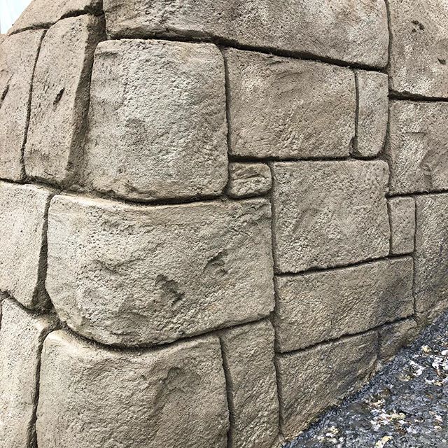 Wall featuring carved and stained shotcrete to mimic natural stone.