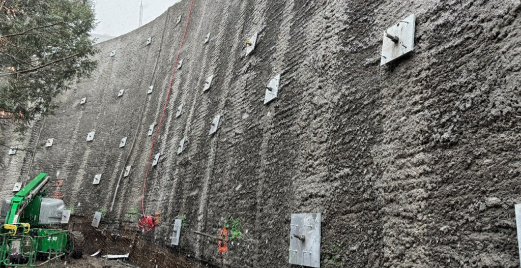 50-foot retaining wall with hollow bar anchor plates, prepared for a shotcrete install.