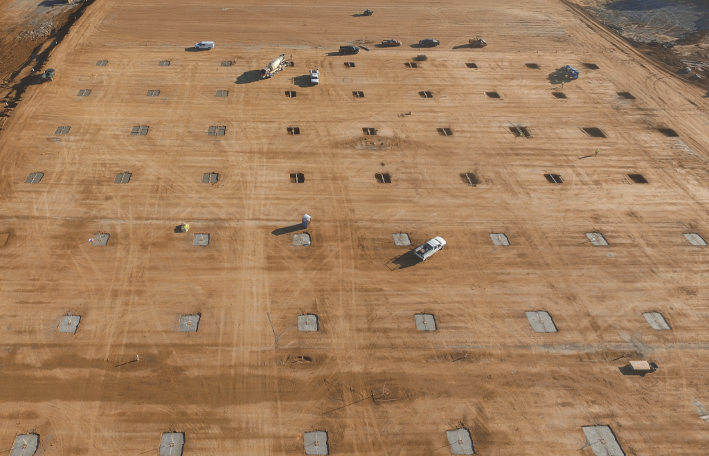 Concrete foundations placed across a building site.